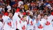 Team Canada players react during the playing of the