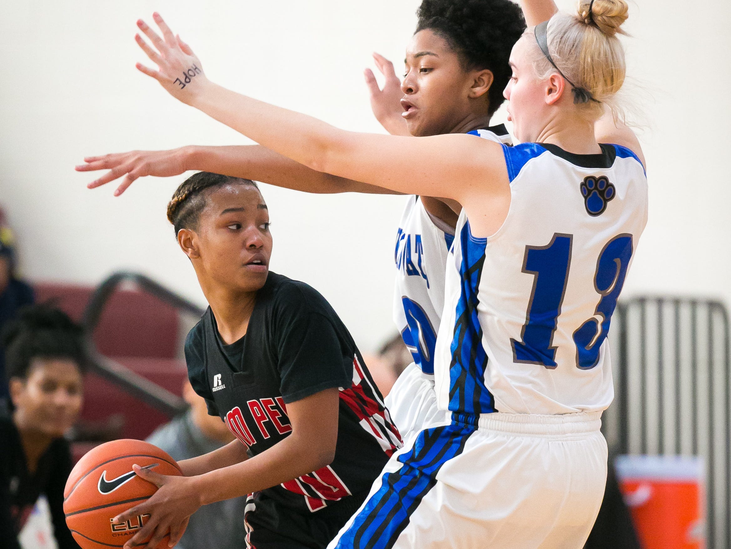 William Penn guard Alize Felton is surrounded by two Howard defenders Shannon Winnington and Ronnasia Blatch-Huggins in the second half.
