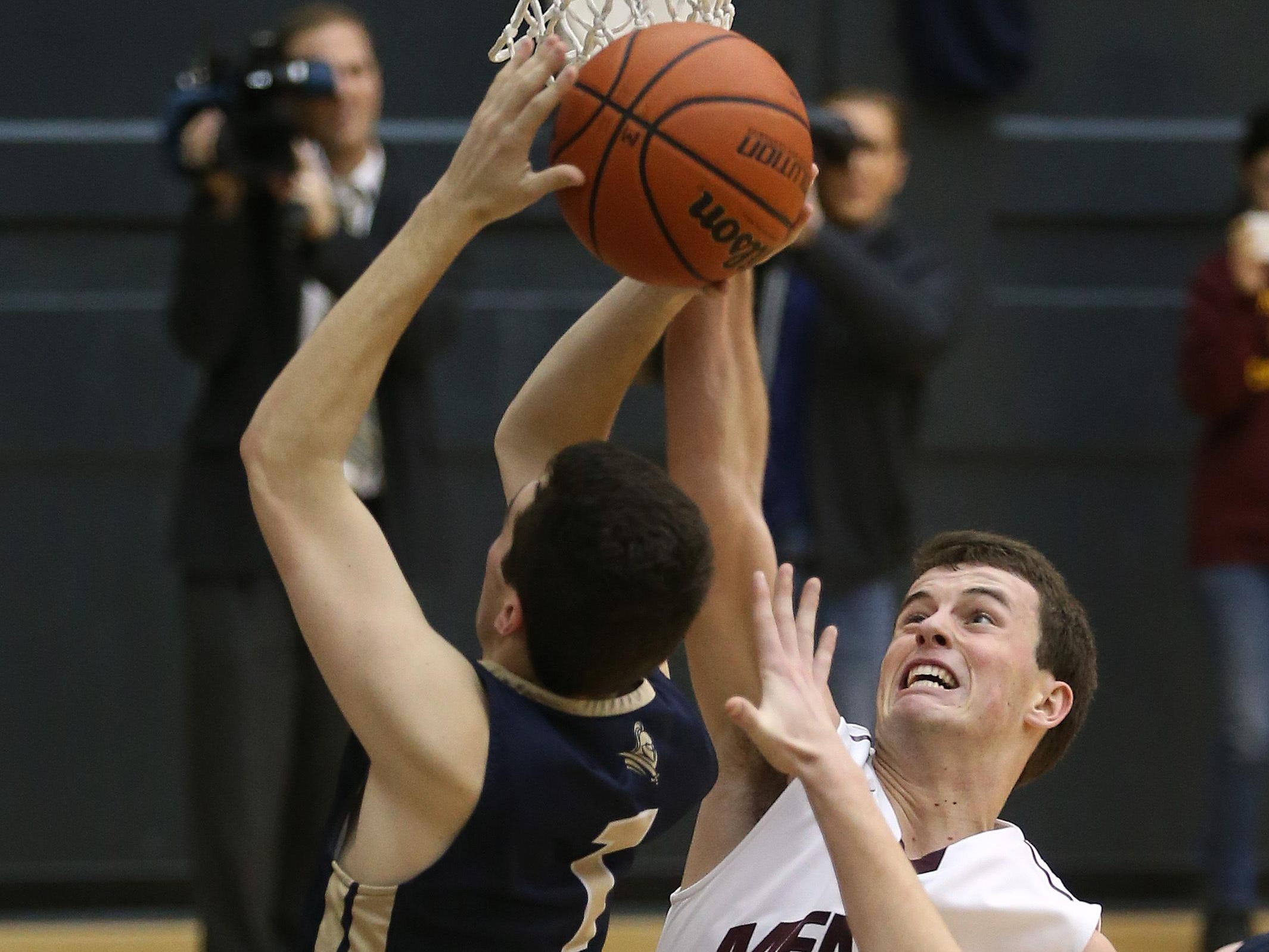 Mendon's Matt Powers goes up with Sutherland's Robbie Doggett (1).