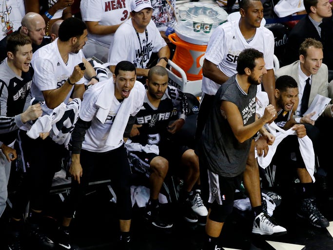 Game 4 in Miami: Spurs 107, Heat 86 -- The bench celebrates a big second-half bucket during San Antonio's blowout win.
