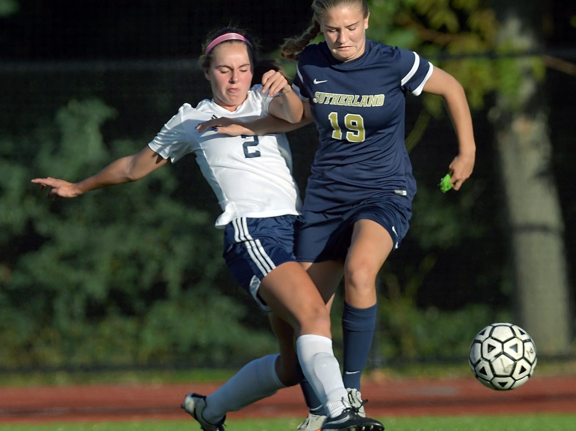 Mercy's Diana Colpoys, left, tackles the ball away from Pittsford Sutherland's Grace Allen.