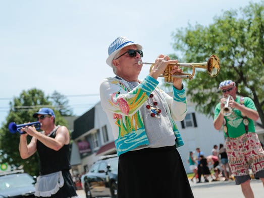 Todd Seabert, center, 56, of Grand Haven plays with