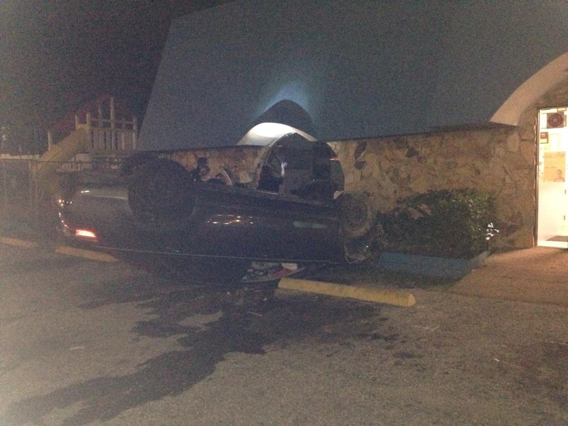 Two women were hurt overnight when their car landed upside down in the parking lot of the Achievement Center for Early Learning building on Busch Blvd.