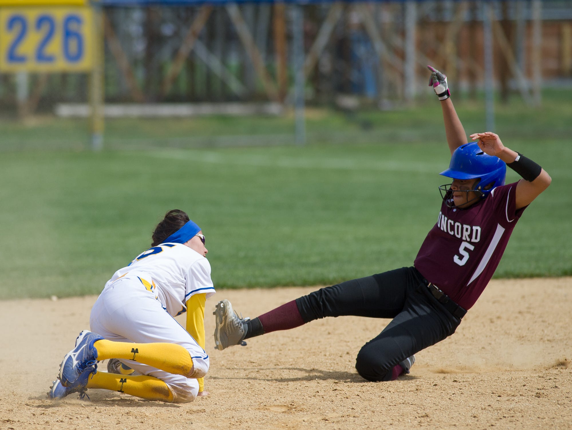 Caesar Rodney's Courtney Malin (15) tags Concord's Makaila Gordy (5) out at second base.