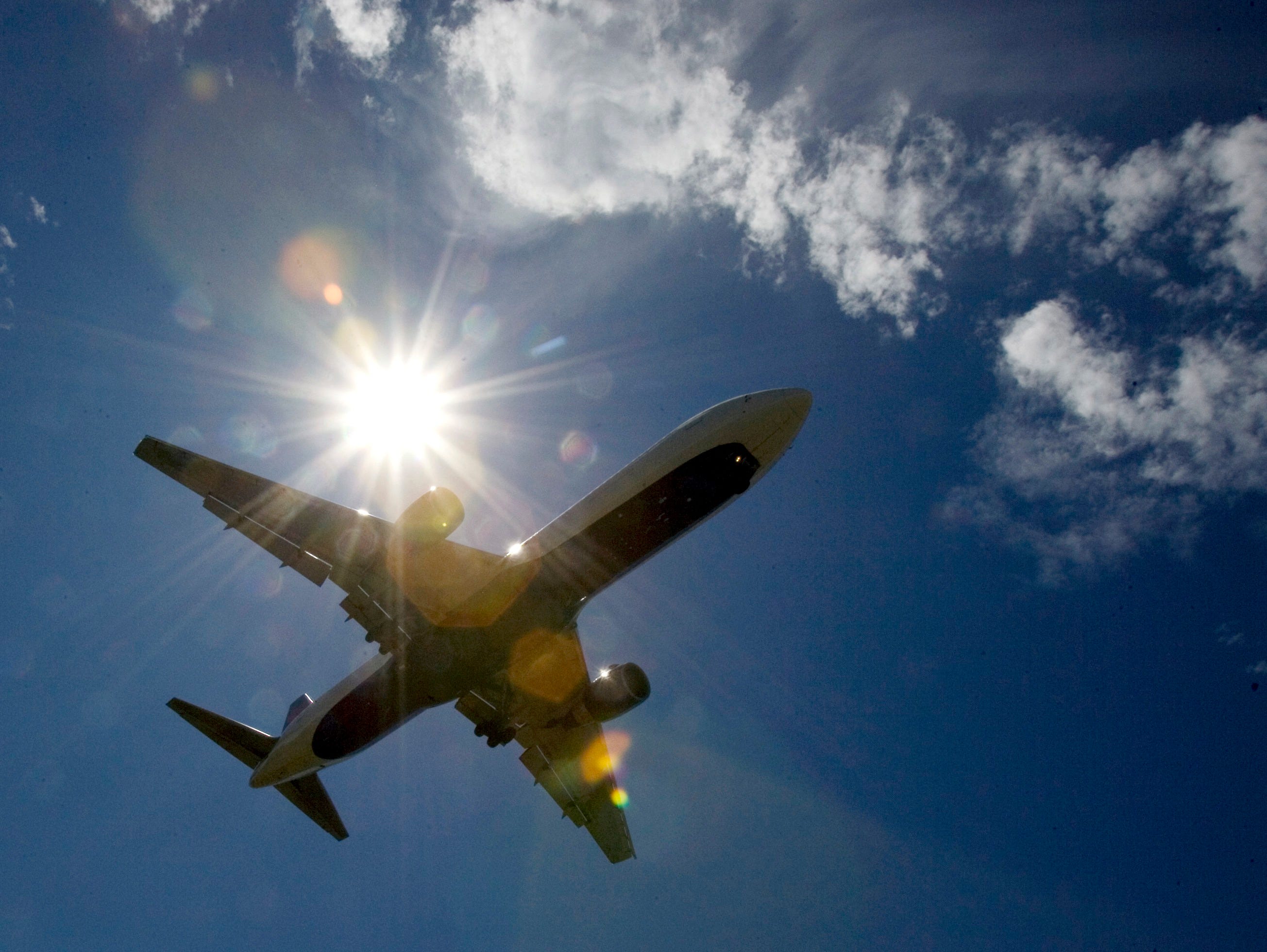 In this July 20, 2009 file photo, a plane flies into Portland International Airport in Oregon.