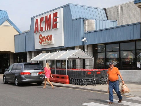 Shoppers walk outside an Acme store on Route 9 in Little Egg Harbor, N.J., where one of the winning lottery tickets in the $448 million Powerball drawing last night was sold.