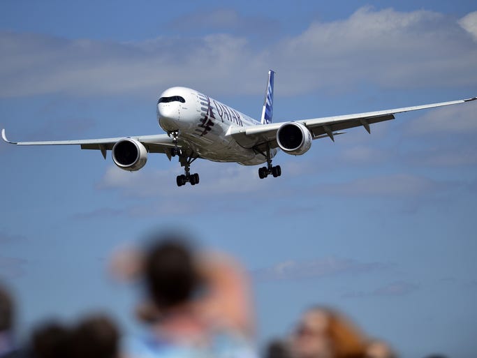 An Airbus A350-900 flies over the runway during a demonstration.