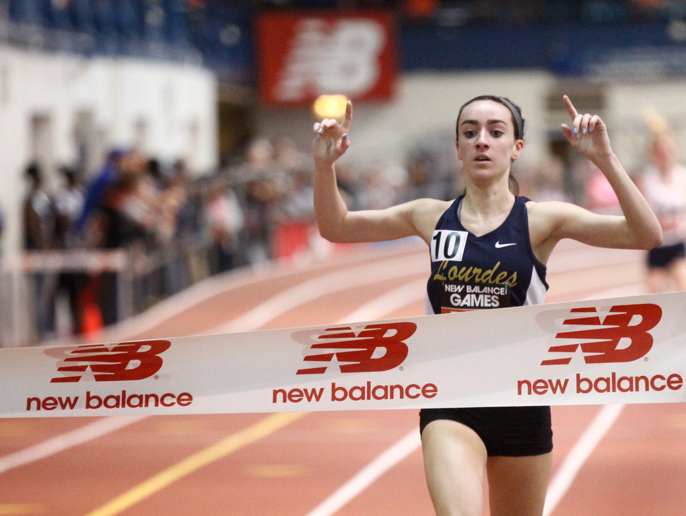 Our Lady of Lourdes' Caroline Timm finishes in first place with a 4:56.25 time in the mile run during the 22nd annual New Balance Games at The Armory New Balance Track & Field Center in New York on Saturday, January 21, 2017.