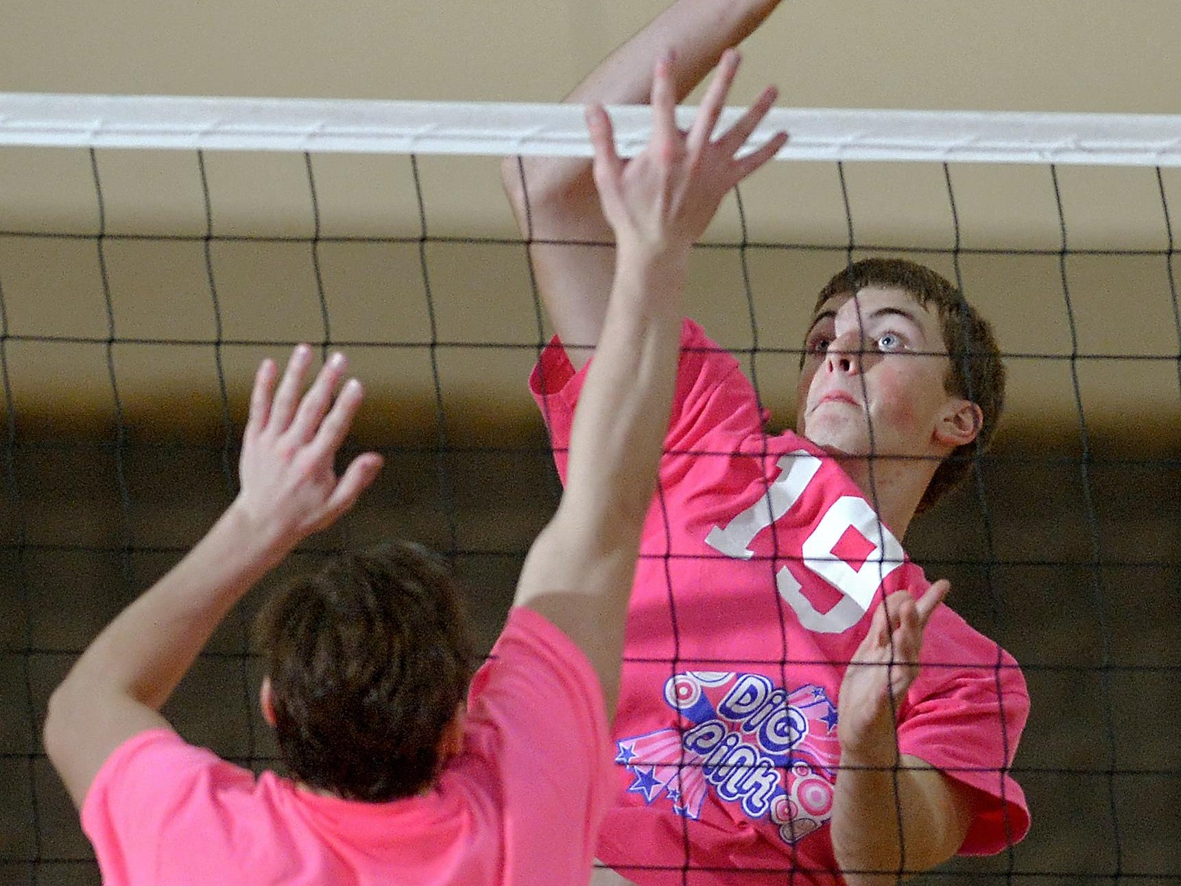 Gates-Chili's Hunter Greenfield, right, hits over the block of Churchville-Chili's Josh Mathews during a regular season game played at Gates-Chili High School on Wedneday, October 14, 2015. The boys and girls varsity volleyball double-header also served as the 5th Annual Dig Pink Event fundraiser to benefit breast cancer research.