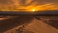 A bright golden sunset in Mesquite Flat Sand Dunes,