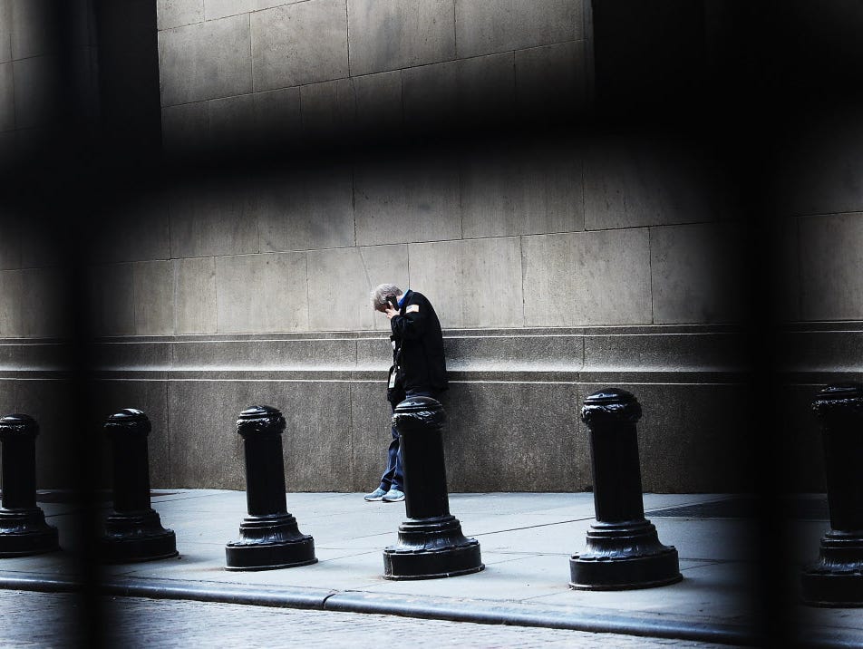 A trader pauses outside of the New York Stock Exchange (NYSE) on August 26, 2016 in New York City. Stocks fell on Friday after news that the U.S. economy grew at the sluggish rate of 1.1 percent.