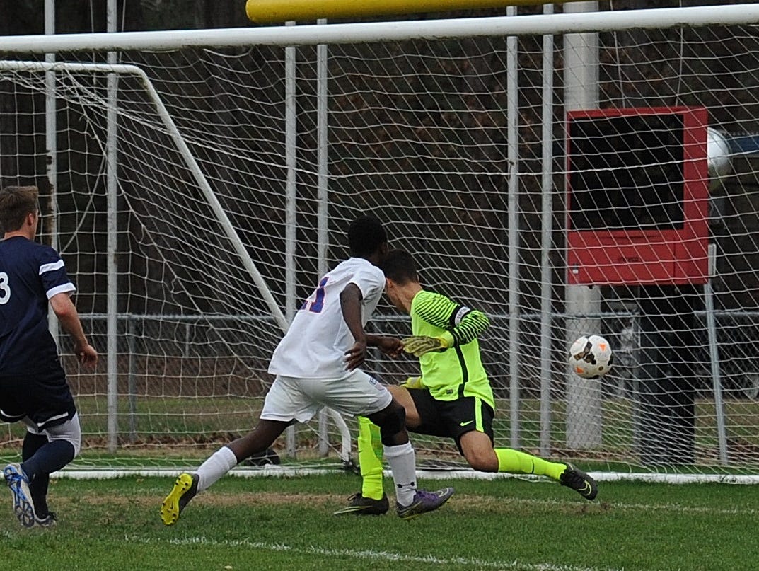 Evangel's Brunel Erickson scores past the Westminster goalie Monday night. Evangel wlon 2-1.