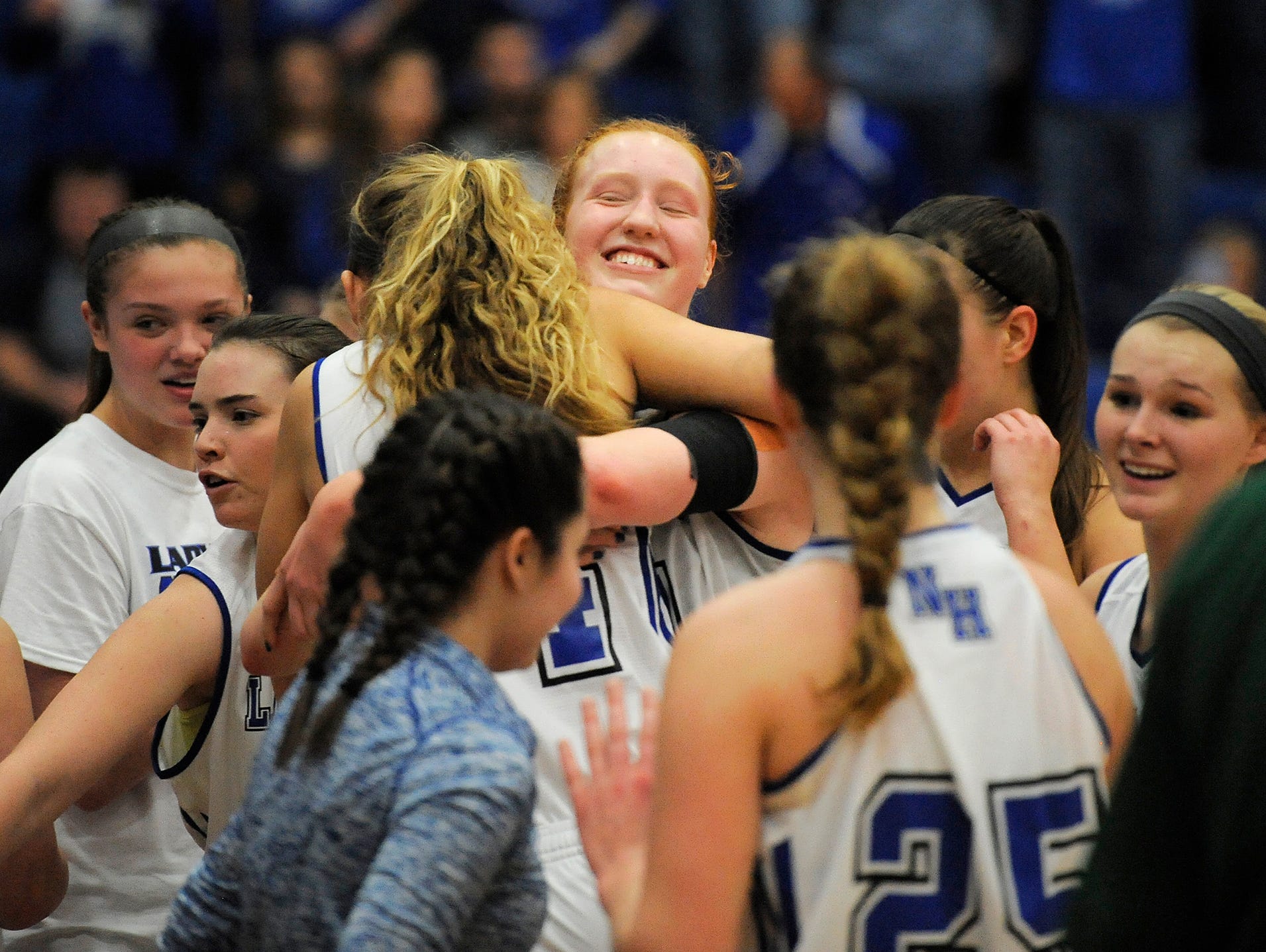 North Harrison's Lilly Hatton (center) is all smiles as the Lady Cats celebrate their 61-48 win over Vincennes-Lincoln on Saturday during the 3A Regional Final game at Charlestown High School. North Harrison won 61-48. (Photo by David Lee Hartlage, Special to The Courier-Journal) Feb. 11, 2017