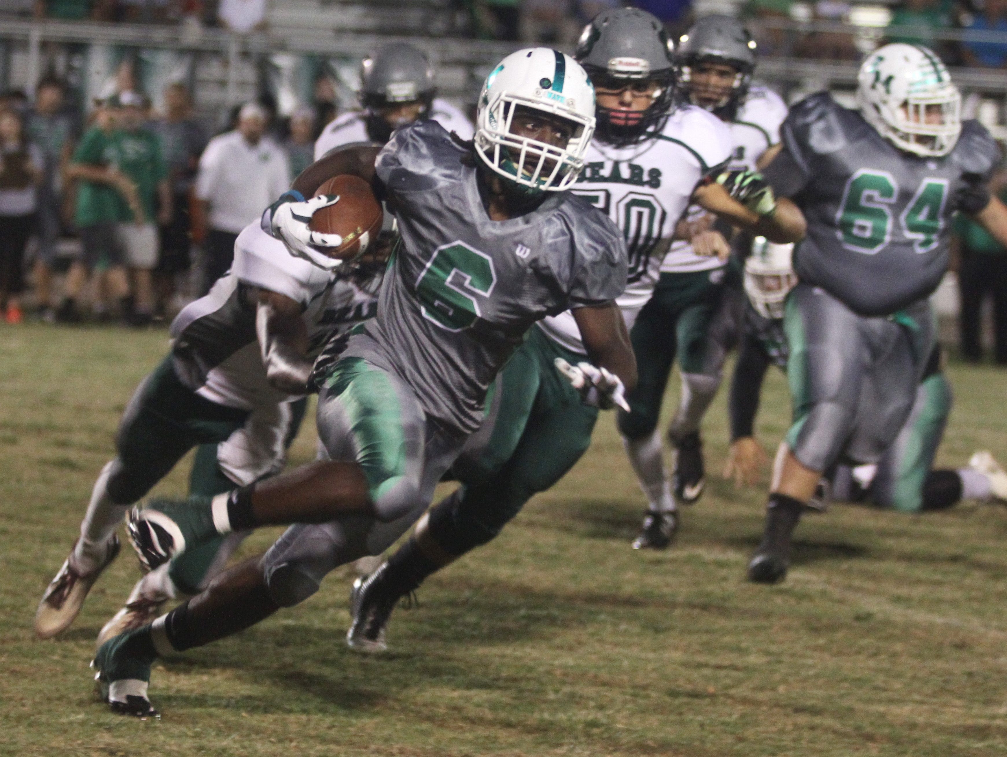 Darrian Felix of Fort Myers runs for a touchdown against Palmetto Ridge on Friday night at Fort Myers High School in November.