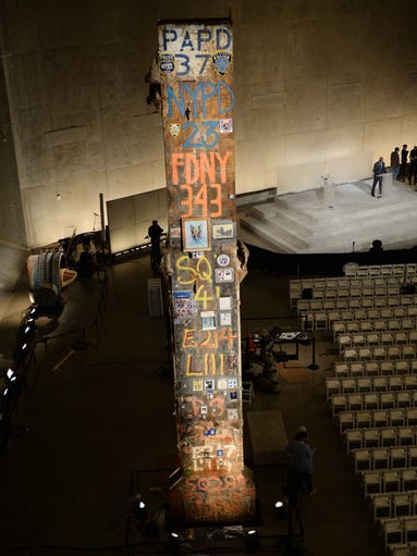 The symbolic Last Column, a steel beam from one of the World Trade Center towers, seen during a press preview of the National September 11 Memorial Museum at the World Trade Center site May 14, 2014 in New York. In the background, preparations are made for the official opening ceremony to be held May 15. AFP PHOTO/Stan HONDA (Photo credit should read STAN HONDA/AFP/Getty Images)