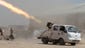 Shiite militia fighters fire a volley of rockets at Islamic State militants on Sept. 3 at Sayed Hassan village outside Tikrit, Iraq.