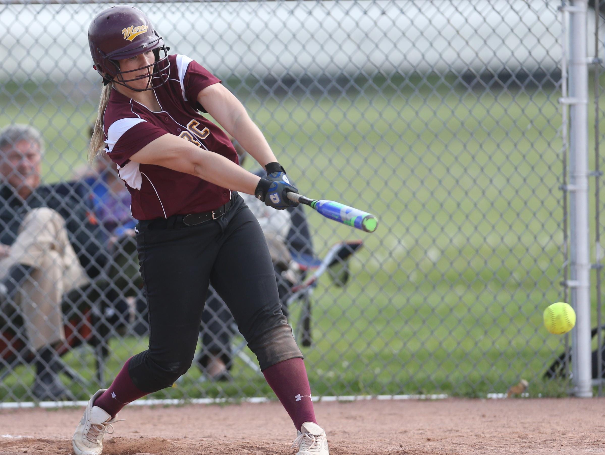 Farmington Hills Mercy’s Abby Krzywiecki bats against host Warren Regina on Wednesday. Krzywiecki hit her school-record 41st career home run and got her 46th career win in the second game of an 11-4, 6-4 sweep.