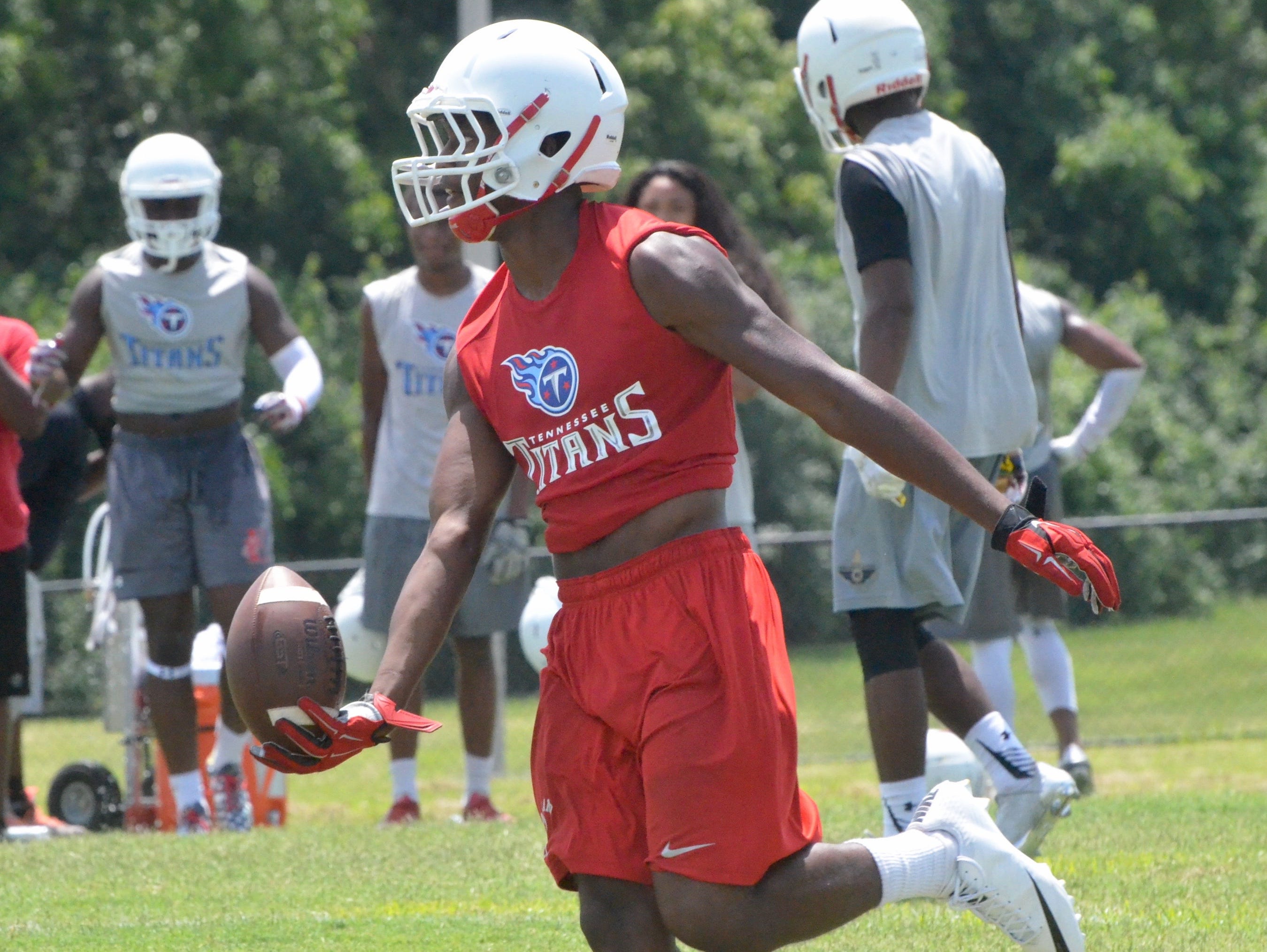 Oakland's Kaleb Oliver celebrates after hauling in an interception during Wednesday's Titans 7-on-7 passing tournament.