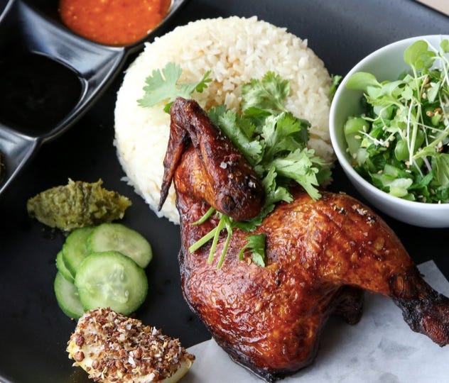 Roasted Spring Chicken is served with rice and a side of Bok Choy.
