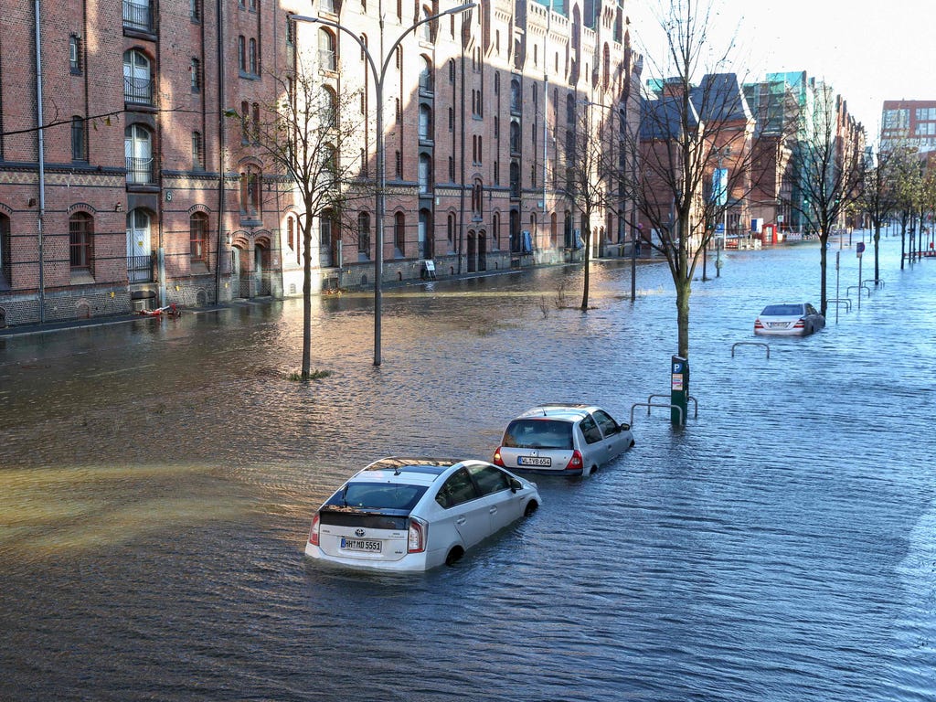 Floodwaters surround cars parked at Hamburg's Fish Market district on Oct. 29, 2017, as a storm hit many parts of Germany. At least three people died in a windstorm that hit central Europe early on on Oct. 29, 2017, causing widespread power outages a