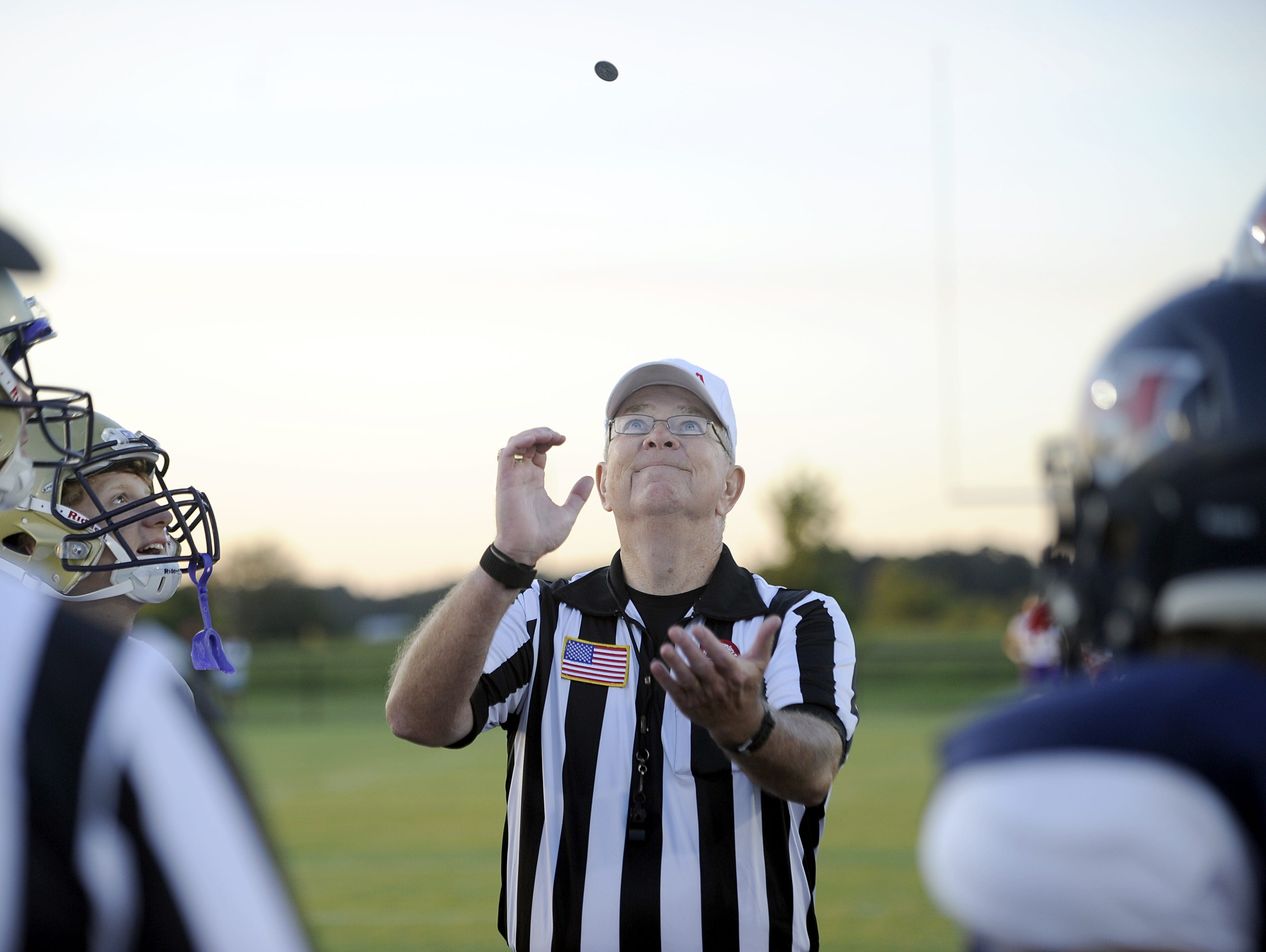 North Middle Football Officials Association referee Jody Swearingen flips the coin prior to kickoff of last Friday's Christ Presbyterian Academy/White House Heritage game.
