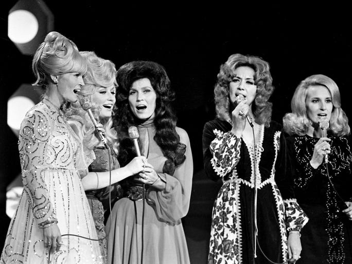 Lynn Anderson, left, Dolly Parton, Loretta Lynn, Dottie West and Tammy Wynette sing a medley around a "country girl" theme during the sixth annual CMA Awards show Oct. 16, 1972.