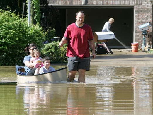 Lou Hanemann pulls wife Natalie, holding Mae, 20 months,