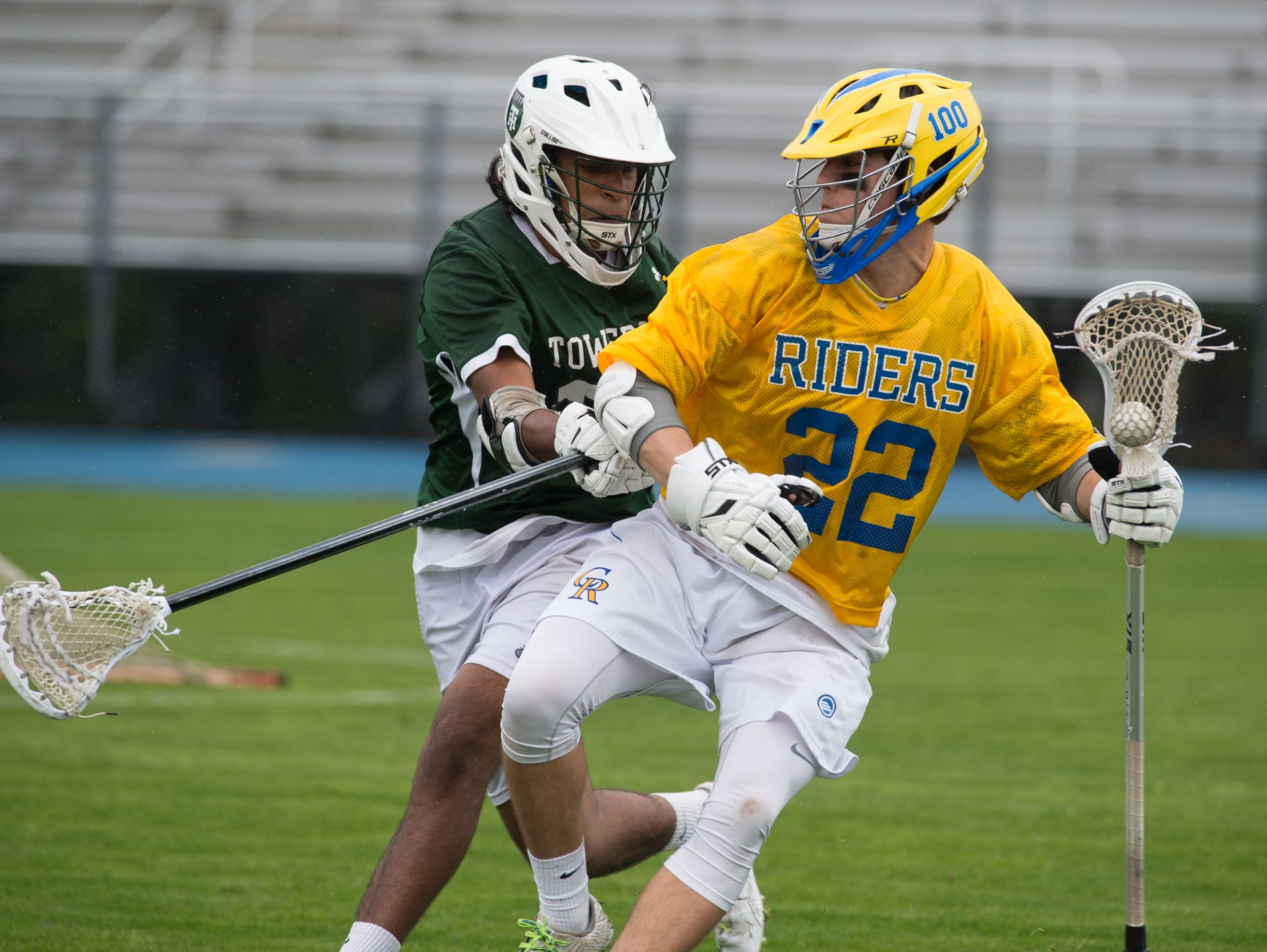 Tower Hill's Tej Vaddi (31), left defends against Caesar Rodney's Jacob Pangle (22).