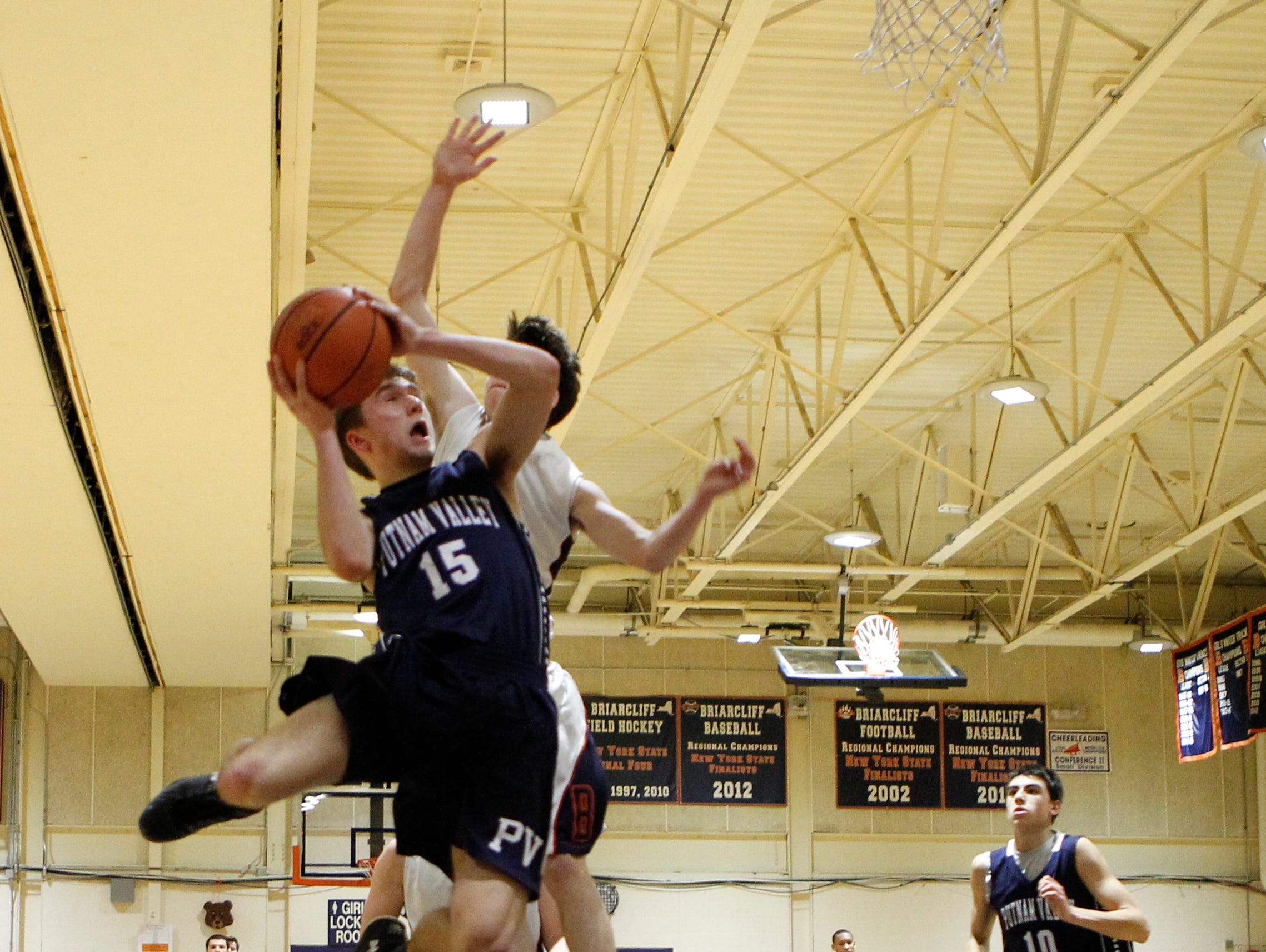Putnam Valley guard Anders Spittal (15) drives against Briarcliff's Sean Crowley (11) at Briarcliff High School on Thursday, Jan. 7, 2016. Briarcliff won 54-48.