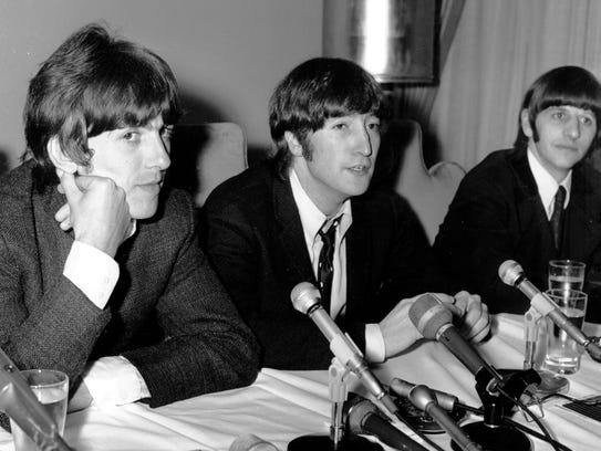 John Lennon (center), flanked by George Harrison and