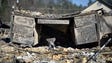 A melted desk rests inside a destroyed building on