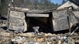 A melted desk rests inside a destroyed building on