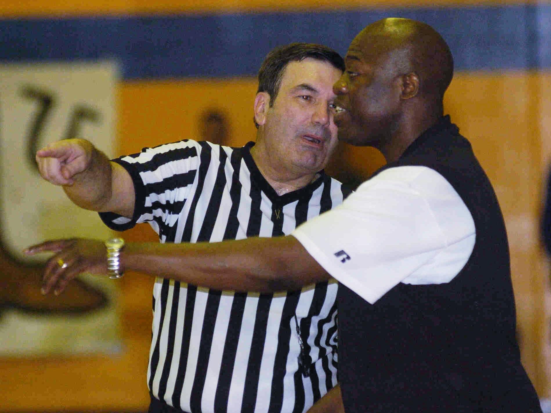 Huntington head coach Mack Jones talks with a referee.