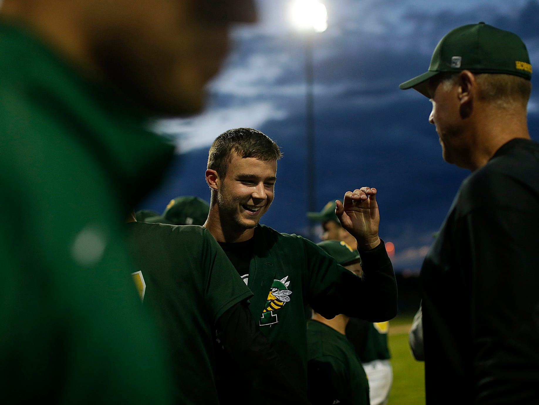 Green Bay Preble pitcher Caleb Schoenholz is congratulated by his coaches after throwing a no-hitter against Green Bay West/East during a WIAA Division 1 sectional finals in June at Bay Port High School in Suamico.