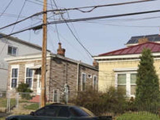 Mark Frazar's yellow Clifton home is shown at right