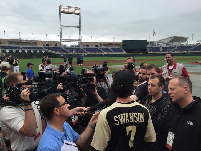 Dansby Swanson meets with the media on the field at