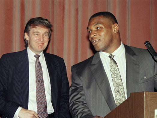 Heavyweight champion Mike Tyson, right, speak at a