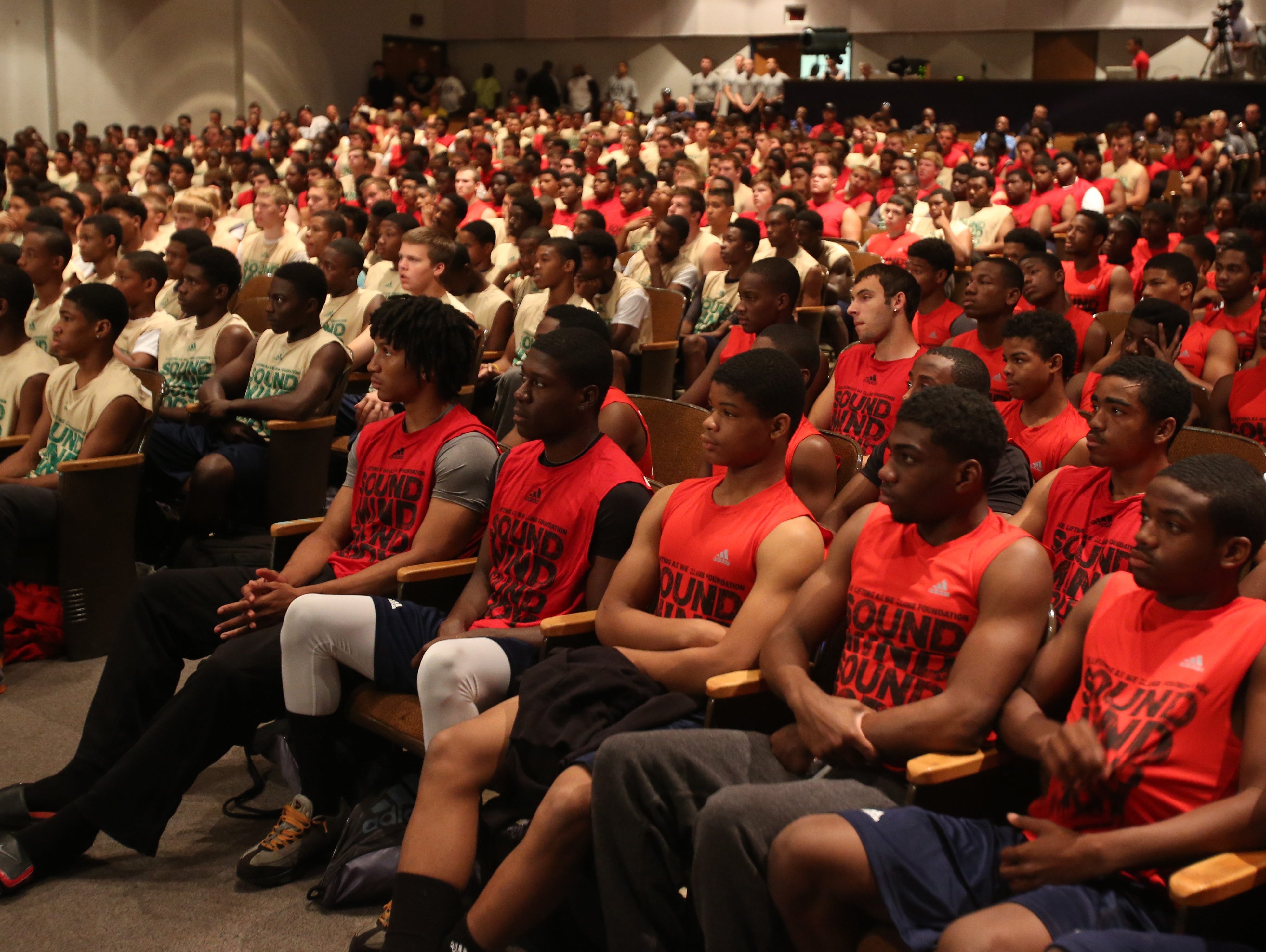 High school football players listen to speakers during the Sound Mind Sound Body football camp at Southfield High School on June 14, 2013.