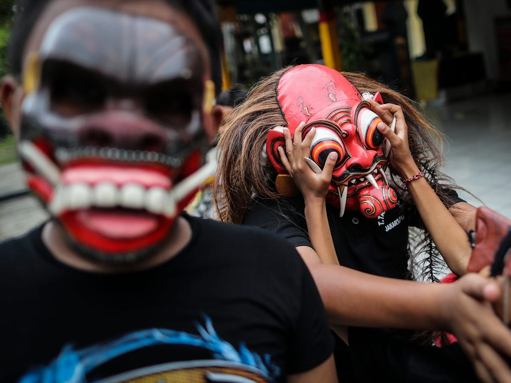 Boys wear masks during a parade on the evening of the Day of Silence locally known as 'Nyepi' that mark Balinese Hindu New Year in Jakarta, Indonesia.