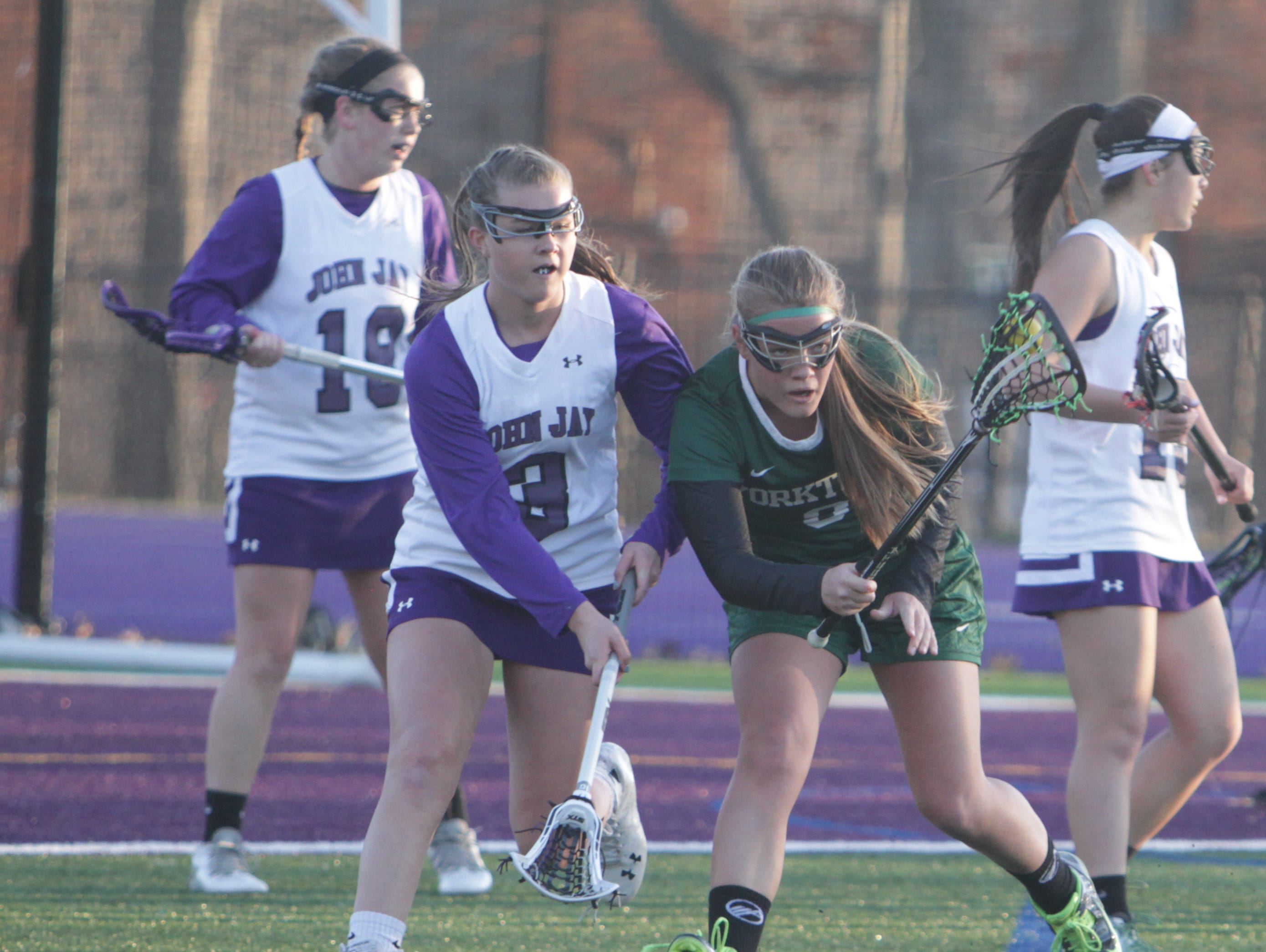 Game action during a Section 1 girls lacrosse game between John Jay and Yorktown at John Jay-Cross River High School on Tuesday, March 29th, 2016. Yorktown won 15-5.