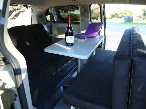 The cargo area transforms from a dining area to a bed
