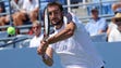 Marin Cilic of Croatia returns a shot for the win against