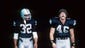 Marcus Allen and Todd Christensen #46 of the Los Angeles Raiders walk out of the tunnel during the game against the Seattle Seahawks at the Los Angeles Memorial Coliseum on October 25, 1987 in Los Angeles, California.