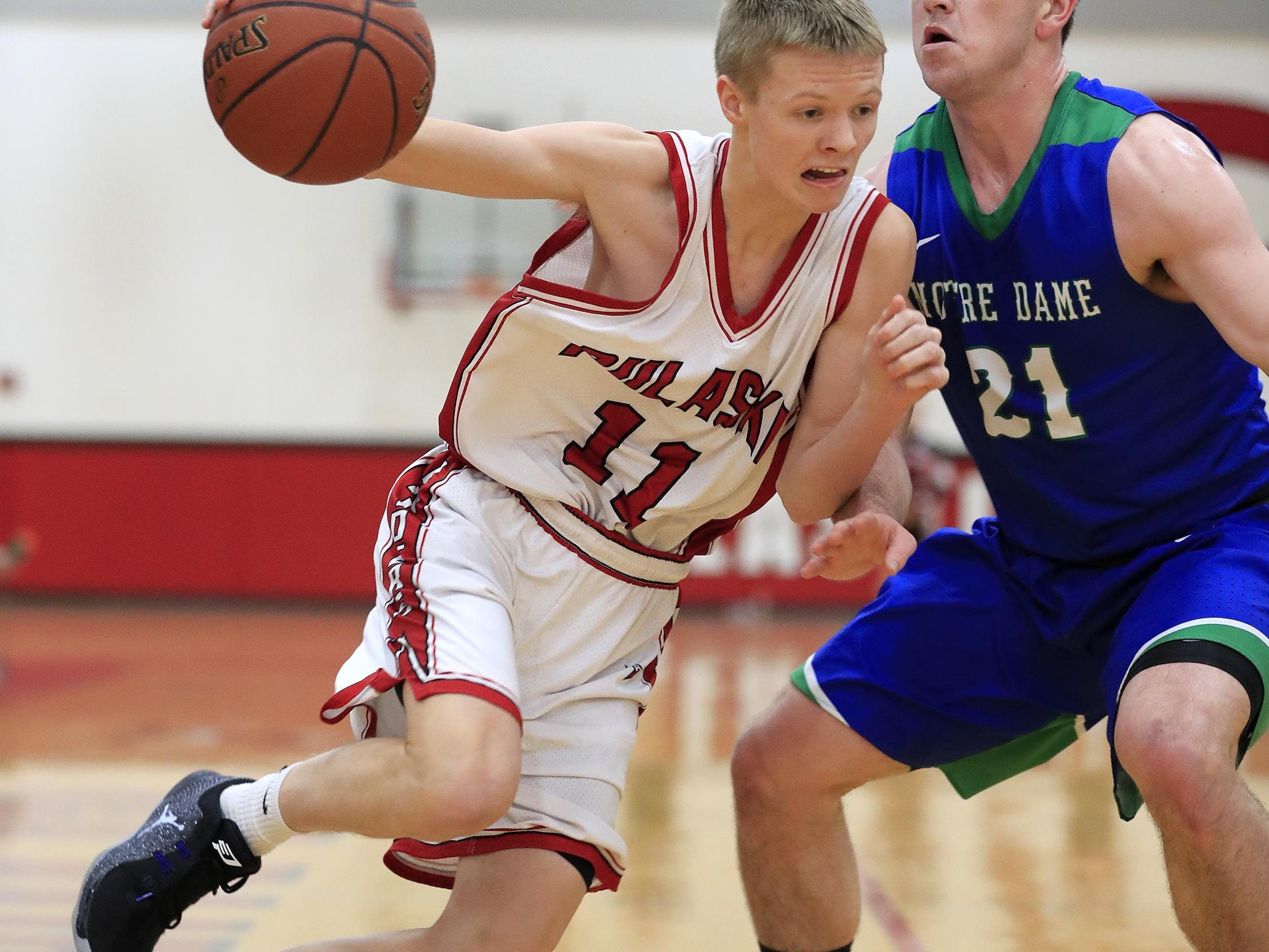 Pulaski’s Griffin Robaidek (11) attempts to dribble past Notre Dame’s Ryan O'Connell (21) on Tuesday at Pulaski.