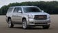The 2015 GMC Yukon XL gets more rear leg!   room and easier-to-use folding second and third rows, similar to Chevrolet Suburban with which it shares components. An SLT model is shown.