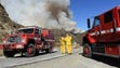 Firefighters monitor a wildfire in Lytle Creek, Calif.,