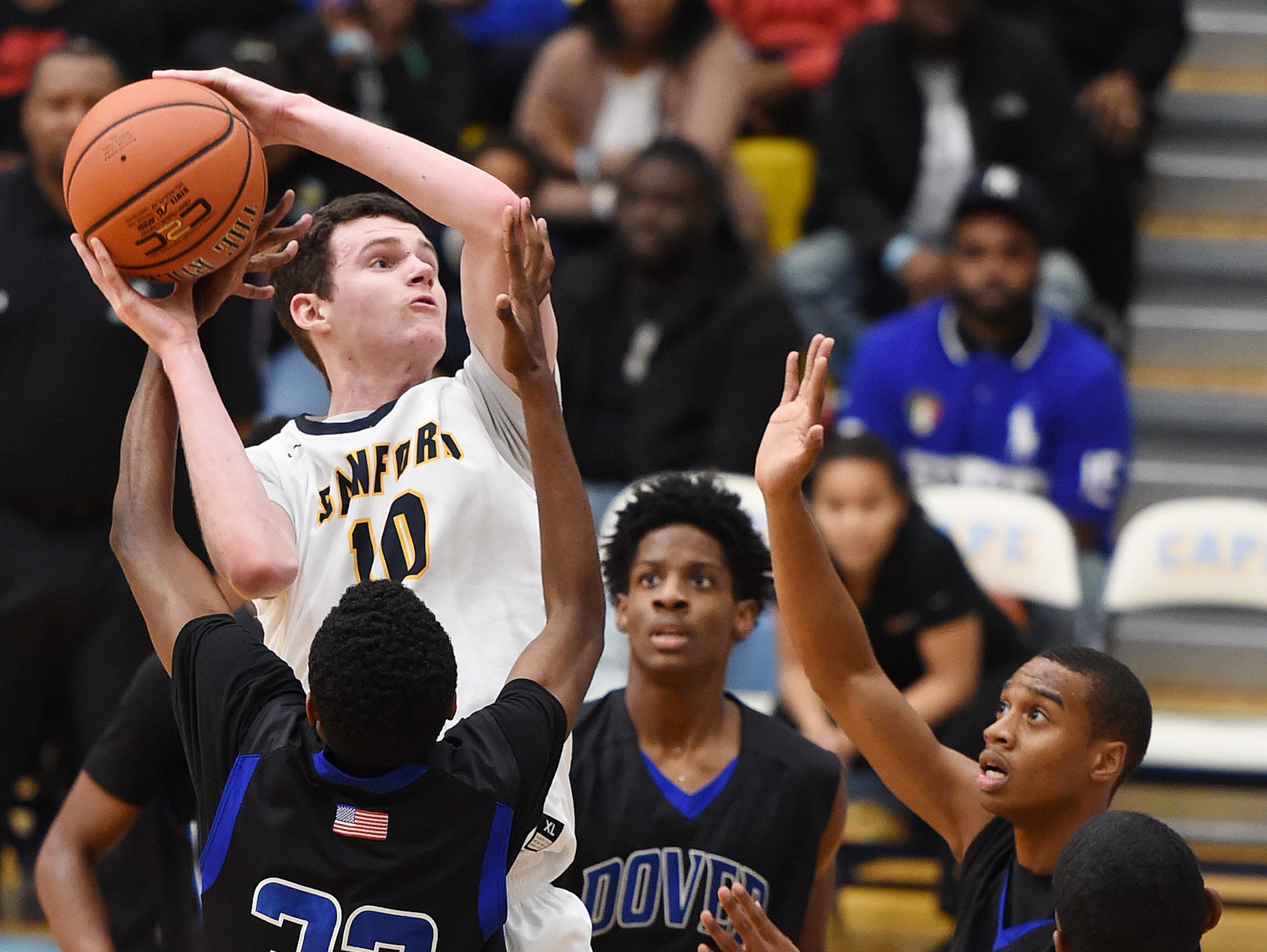 Sanford's Jacob Walsh (10) scores over three Dover defenders at Slam Dunk to the Beach on Dec. 27 at Cape Henlopen High. The Warriors are the No. 1 seed in the upcoming DIAA Boys Basketball Tournament.