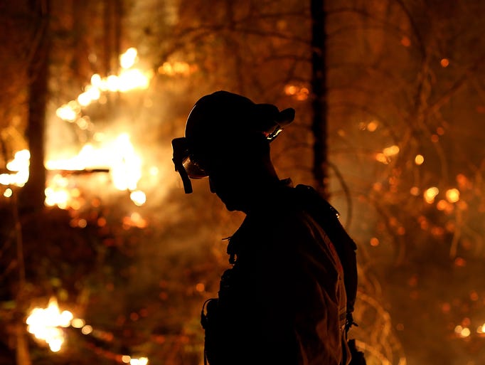 A firefighter monitors a back fire while battling the Rim Fire on Aug. 22 in Groveland, Calif. The Rim Fire is out of control and threatens 2,500 homes outside Yosemite National Park.