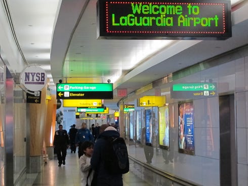 Passengers maneuver through one of the cramped hallways at New York's LaGuardia Airport on Jan. 10, 2014.