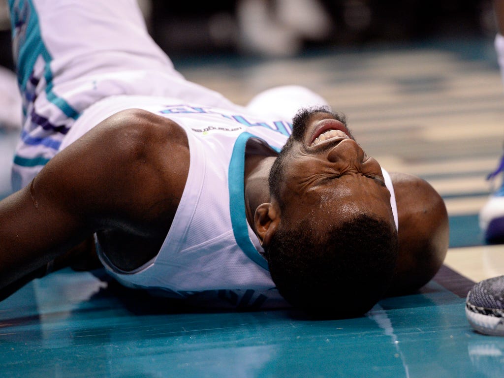 Charlotte Hornets forward Michael Kidd-Gilchrist lays in pain after hitting the ground hard during the second half against the Washington Wizards at the Spectrum Center in Charlotte, N.C. The Hornets won 133-109.
